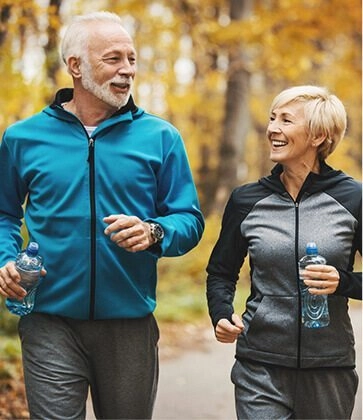 Senior couple talking to each during jogging